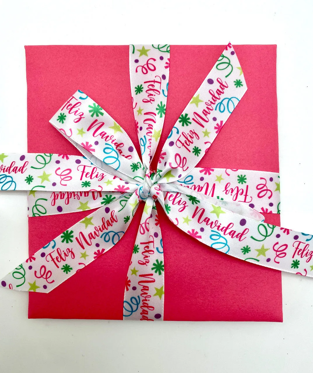 Feliz Navidad Ribbon with confetti and streamers in pink, green, blue and purple printed on 5/8" white single face satin